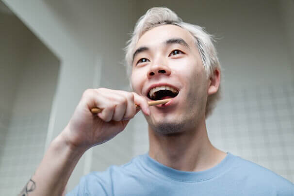 dental care with man regularly brushing his teeth
