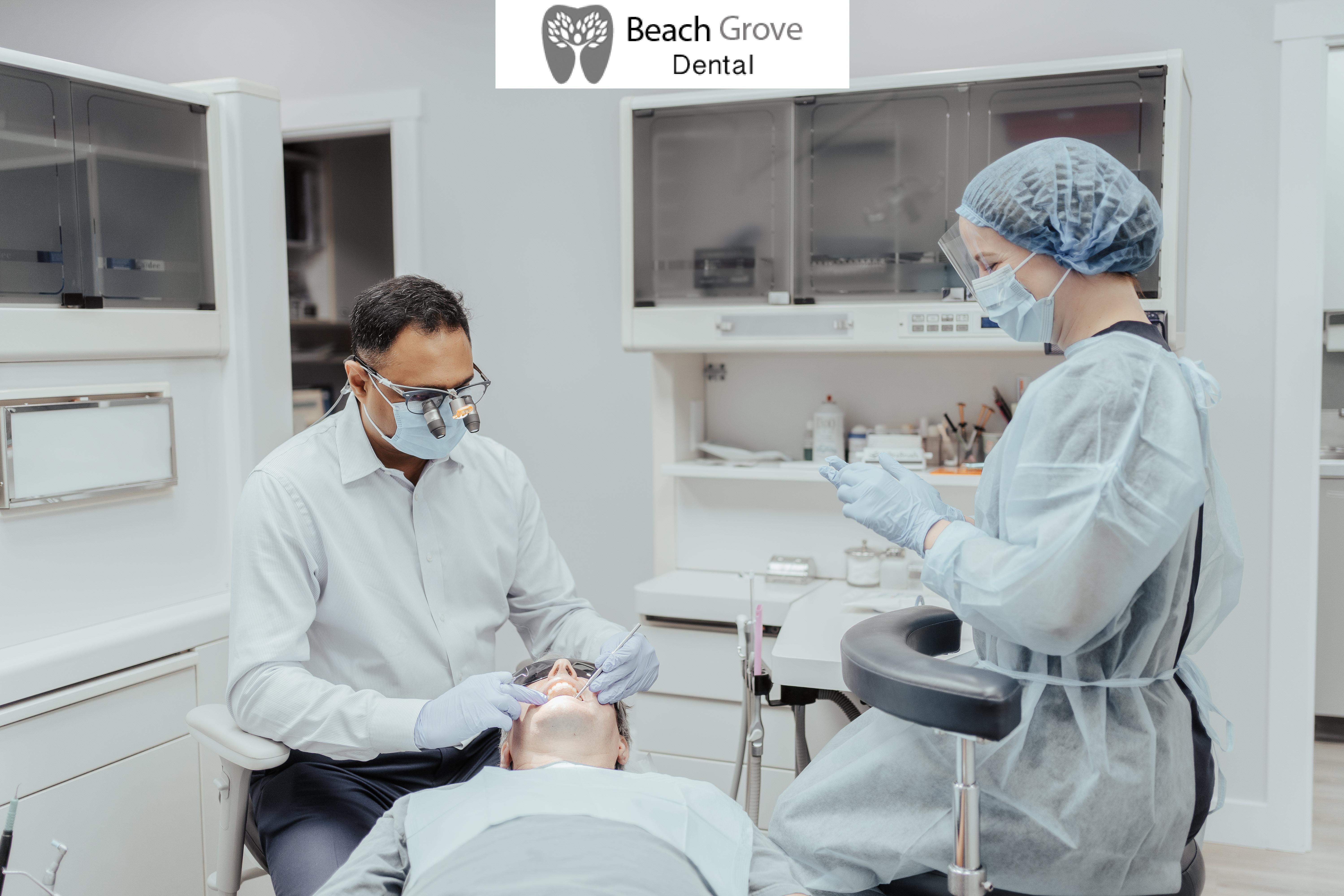 Dr Beeram and assistant at Beach Grove Dental maintaining the oral health of a patient
